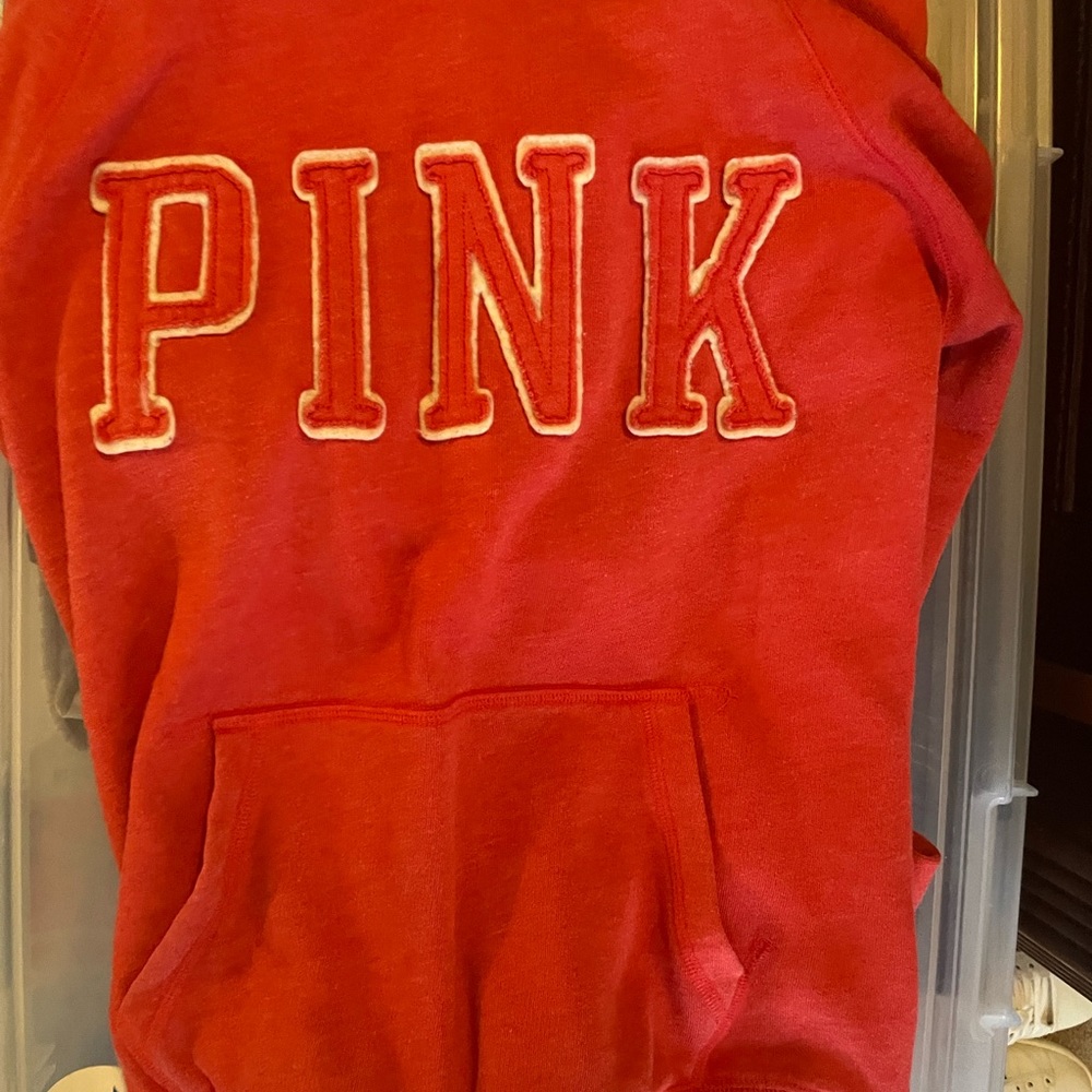 Small Pink sweatsuit with hoodie top. The color is a cross between peach/ red